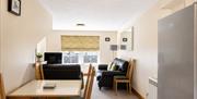 Dining area and living room in Number 10 at Howgills Apartments in Sedbergh, Cumbria
