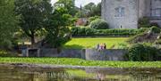 By the water on the grounds at Sizergh Castle, Lake District - National Trust