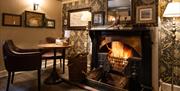 Real log fire and seating at The Pheasant Inn in Bassenthwaite, Lake District