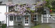 Front showing slate 'seatstone' of Wistaria Cottage in Elterwater, Lake District