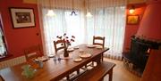 Dining room and fireplace at Armidale Cottages Bed & Breakfast in High Seaton, Cumbria