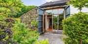 Front door and gardens at Upper Crumble Cottage at Crumble Cottages near Cartmel, Lake District