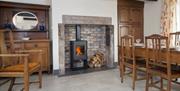 Wood burner in kitchen and dining area in a Manesty cottage