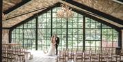 Bride and groom pose for a photo at Hidden River Barn near Longtown, Cumbria