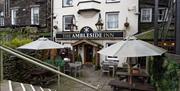 Outdoor seating and entrance to The Ambleside Inn in Ambleside, Lake District