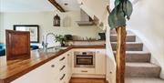 Kitchen and stairs at Crumble Cottage at Crumble Cottages near Cartmel, Lake District