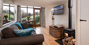 Sitting room and wood burner at Upper Crumble Cottage at Crumble Cottages near Cartmel, Lake District