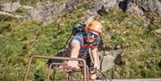 Climber at Via Ferrata Xtreme at Honister Slate Mine in Borrowdale, Lake District