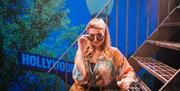 Actor performing on stage at The Victoria Wood Theatre in Bowness-on-Windermere, Lake District