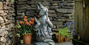 Garden plants and decor at The Peter Rabbit Garden at The World of Beatrix Potter in Bowness-on-Windermere, Lake District