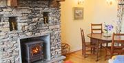 Dining area and fireplace in Pheasant Cottage at Wall Nook Cottages near Cartmel, Cumbria
