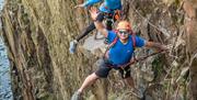 Climber Waving at the Camera at Via Ferrata Xtreme at Honister Slate Mine in Borrowdale, Lake District