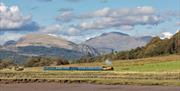 Ravenglass & Eskdale Railway train with scenic mountains © Mark Fielding