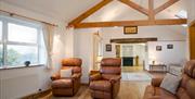 Lounge, entrance and kitchen in open plan layout in a Manesty Cottage
