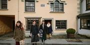 Happy visitors at Beatrix Potter Gallery in Hawkshead, Lake District