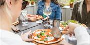 Guests Enjoying Woodfired Pizzas at Another Place, The Lake, Ullswater in Watermillock, Lake District