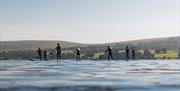 Guests on Stand Up Paddleboards from Another Place, The Lake, Ullswater in Watermillock, Lake District