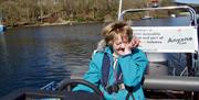 Visitors Riding a Boat with Anyone Can in the Lake District, Cumbria