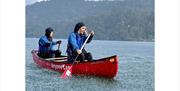 Visitors Canoeing with Anyone Can in the Lake District, Cumbria