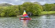 Colourful canoe sail on spring back ground