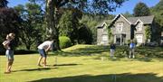 Guests playing croquet on the grounds at Hazel Bank Country House Hotel in Rosthwaite, Lake District