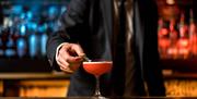 Bartender Adding a Garnish to a Drink at Lake View Restaurant, Armathwaite Hall Hotel and Spa in Bassenthwaite, Lake District