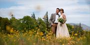 Happy Couple Posing for Wedding Photos at Armathwaite Hall Hotel and Spa in Bassenthwaite, Lake District