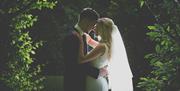 Happy Couple Posing for Wedding Photos at Armathwaite Hall Hotel and Spa in Bassenthwaite, Lake District