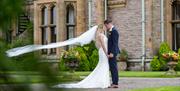 Happy Couple Posing for Wedding Photos at Armathwaite Hall Hotel and Spa in Bassenthwaite, Lake District