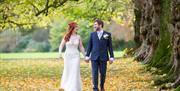 Happy Couple Posing for Wedding Photos on the Grounds at Armathwaite Hall Hotel and Spa in Bassenthwaite, Lake District