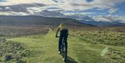 Visitor Riding a Mountain Bike from Arragon's Cycle Hire at Lowther Castle in Penrith, Cumbria