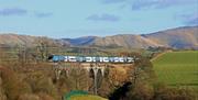 Avanti West Coast train travelling through the Lake District countryside