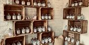 Shelves at Black Cat Distillery at Brougham Castle near Penrith, Cumbria