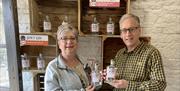 Smiling Visitors at a Gin Making Workshop at Black Cat Distillery at Brougham Castle near Penrith, Cumbria