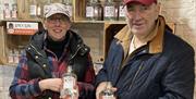 Smiling Visitors at a Gin Making Workshop at Black Cat Distillery at Brougham Castle near Penrith, Cumbria