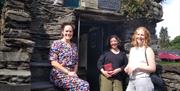 Visitors outside of Bridge House, as part of The Bridge House Mystery Escape Box Experience at The Armitt Museum in Ambleside, Lake District