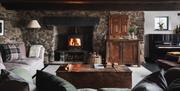 Cosy living room with real wood burner in a Boutique Retreats Cottage in the Lake District, Cumbria