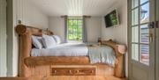Interior of Bluebell Lodge, with double bed, at Coniston Shepherd Hut Lodges in Coniston, Lake District