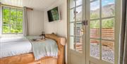 View from double bed inside Bluebell Lodge at Coniston Shepherd Hut Lodges in Coniston, Lake District