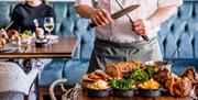 Chef Carving in the Restaurant at The Borrowdale Hotel in Borrowdale, Lake District