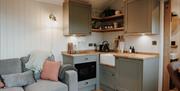 Kitchenette and sofa at Brackenslack Shepherds Huts in Maulds Meaburn, Cumbria
