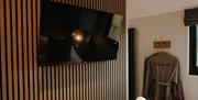 TV and dressing gowns at Brackenslack Shepherds Huts in Maulds Meaburn, Cumbria