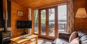 Lounge and Views from Buzzard Lodge at The Tranquil Otter in Thurstonfield, Cumbria