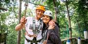 Visitors smiling while ziplining with Lake District Calvert Trust