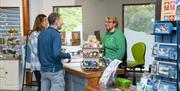 Visitors shopping at the visitor centre at Whinlatter Forest in the Lake District, Cumbria