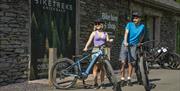 Cyclists at Biketreks shop at Grizedale Forest in the Lake District, Cumbria