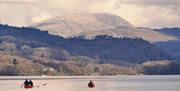 Accessible canoeing on lake windermere with mountains in background