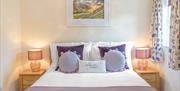 Double Bedroom with Decorative Pillow that reads "Hello World" at Springbank Cottage in Coniston, Lake District