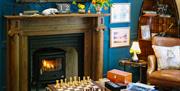 Lounge, Chessboard, and Fireplace at 1863 Bar Bistro Rooms in Ullswater, Lake District