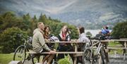Cyclists taking a break at Wray Castle, Low Wray, Ambleside, Lake District